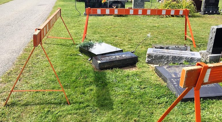 Fainting motorist knocks over headstones